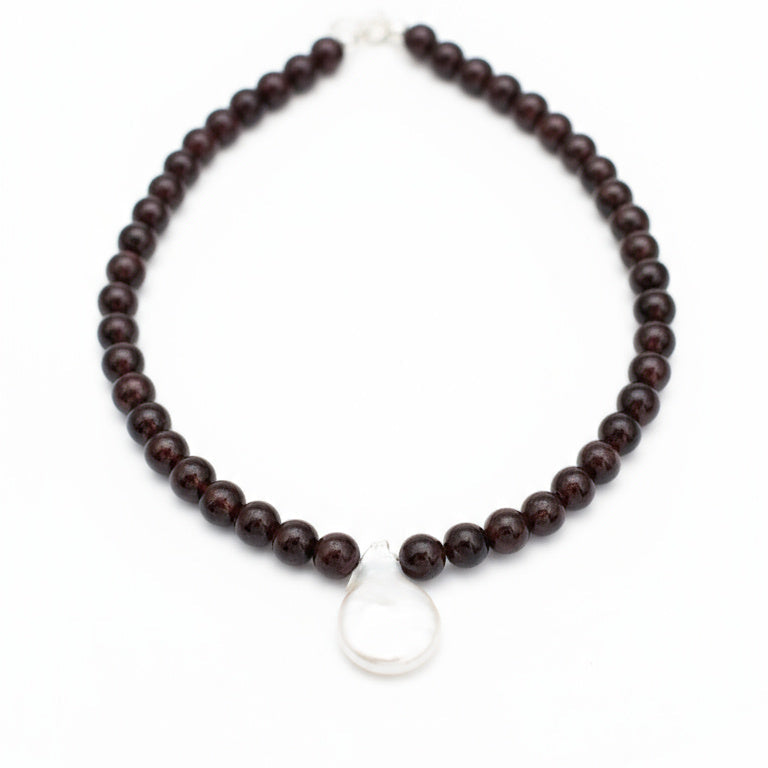 Wooden beaded necklace with a silver clasp on a white background