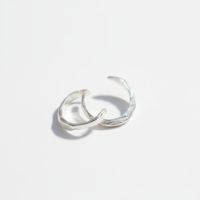 Silver ear cuff on a light gray background