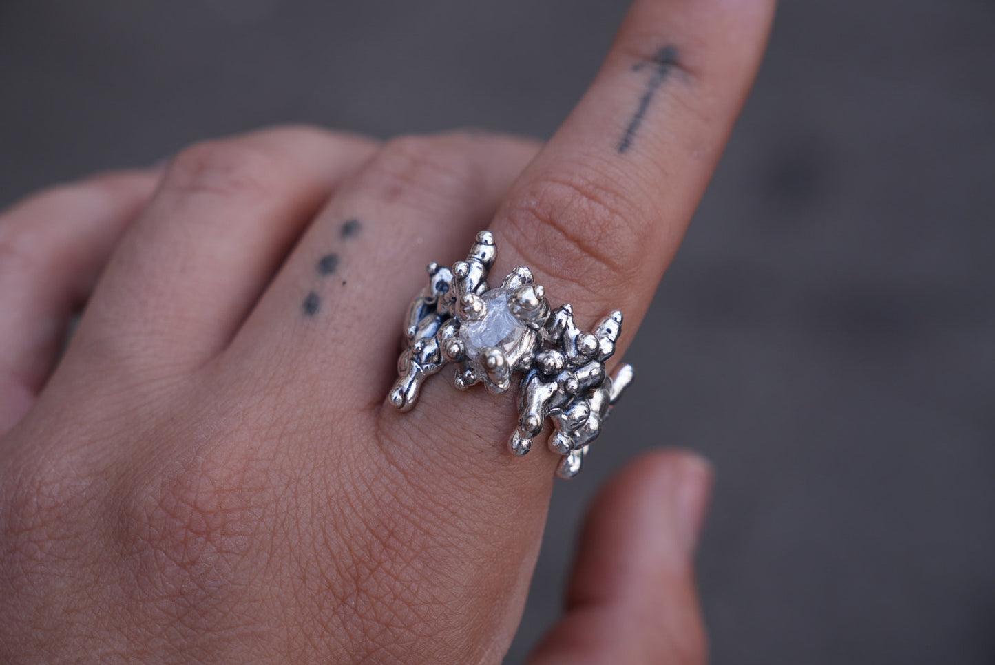 All over silver ring set with stone
