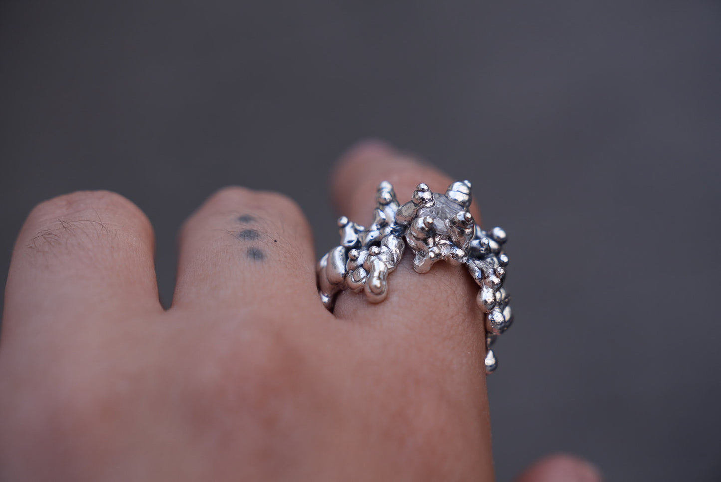 All over silver ring set with stone