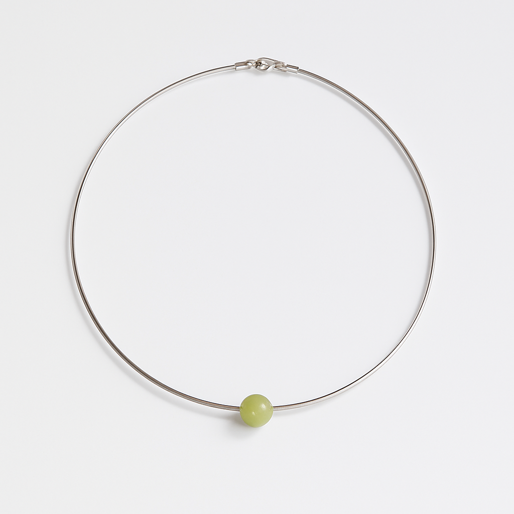 Necklace with a green bead on a white background
