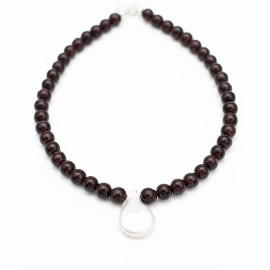 Wooden beaded necklace with a silver clasp on a white background