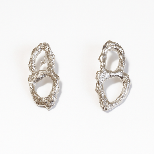 Pair of silver earrings on a white background
