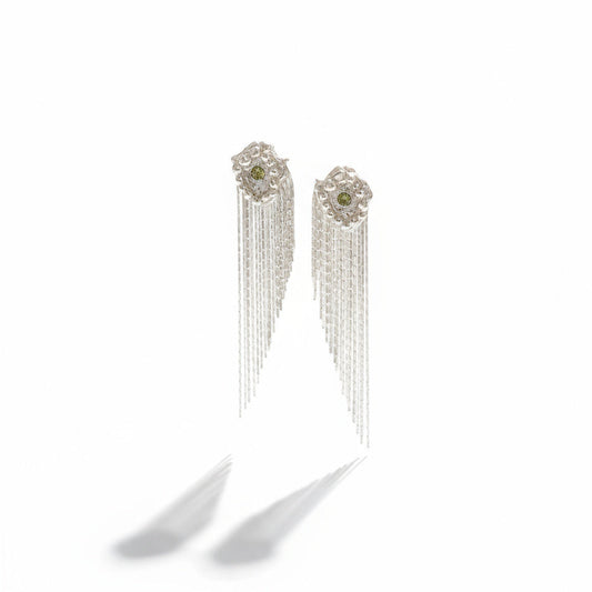 Pair of silver earrings with green gemstones on a white background