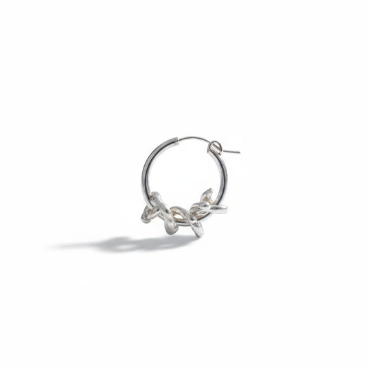 Silver hoop earring on a white background